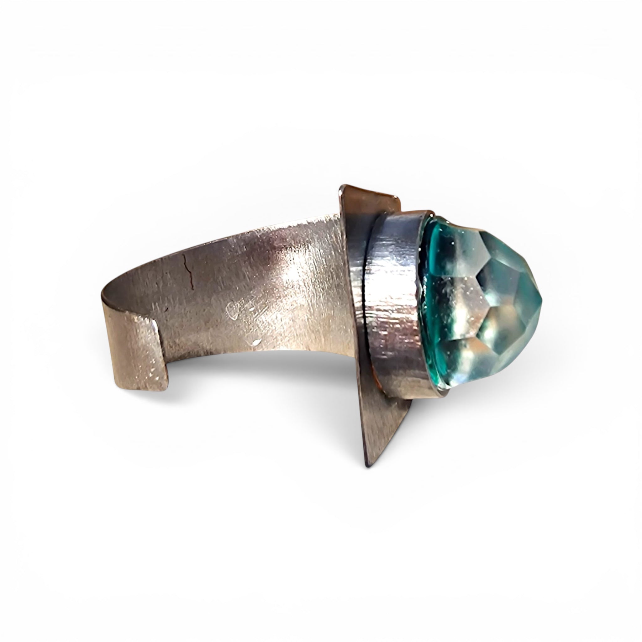 Selce wrought iron cuff bracelet close-up — transparent teal Murano glass handmade in Venice